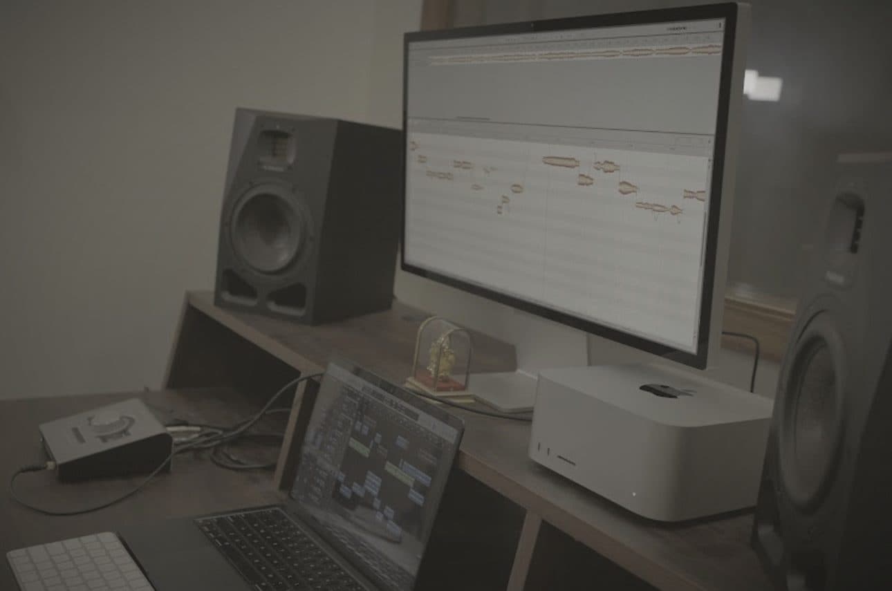 Melodyne pitch editing on the studio monitor, flanked by ADAM Audio A7V speakers
